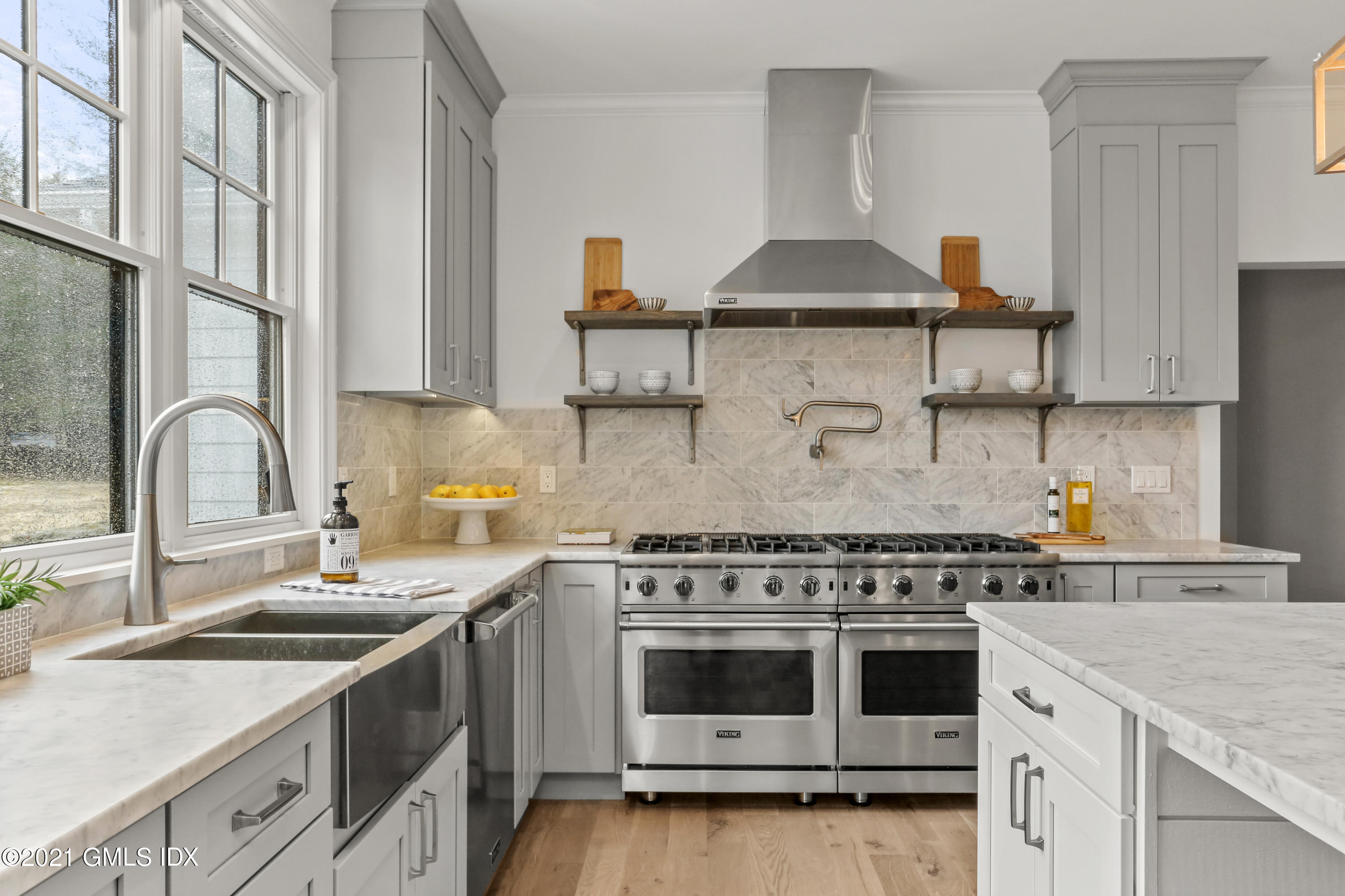 12 Cottontail Road Cos Cob, CT 06807 - Photo 10 of 35 a kitchen with stainless steel appliances granite countertop a sink stove and white cabinets