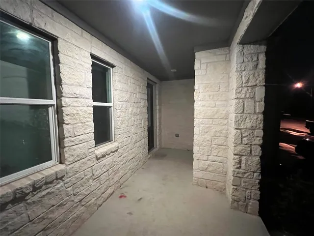 a view of kitchen with stainless steel appliances wooden floor and living room view