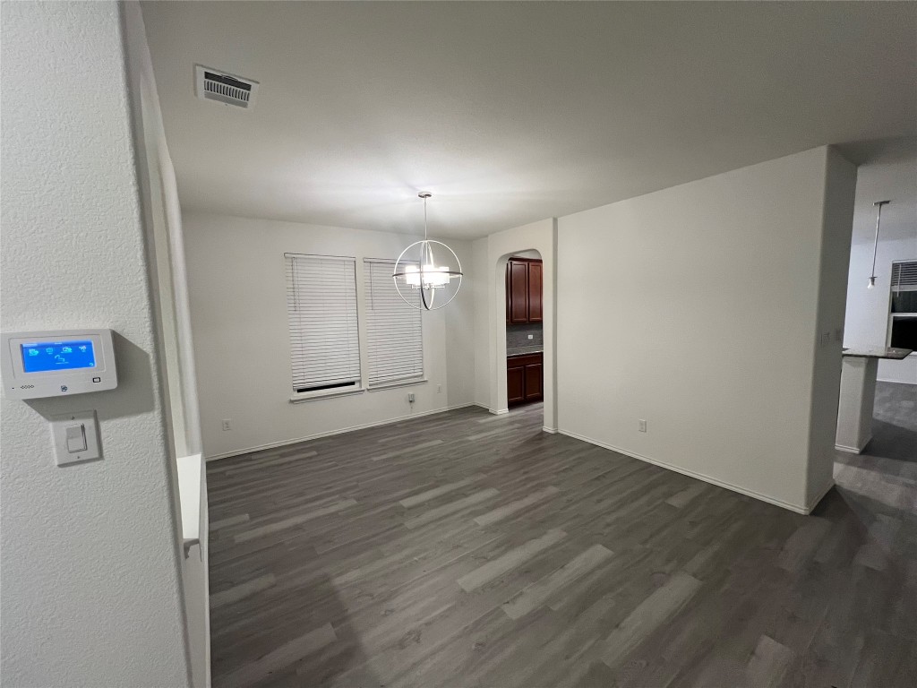 112 West Point Way Elgin, TX 78621 - Photo 7 of 9 an empty room with wooden floor and a hallway