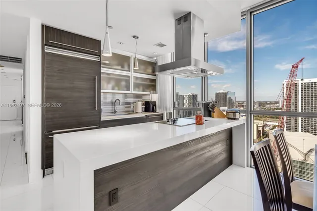 a kitchen with stainless steel appliances kitchen island granite countertop a sink and cabinets