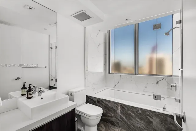 a bathroom with a sink toilet and shower