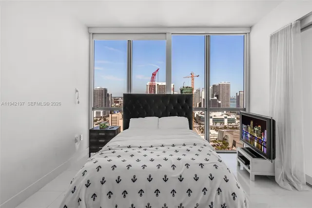 a bedroom with a bed and a dresser