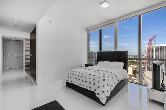 a bedroom with a bed and a night stand