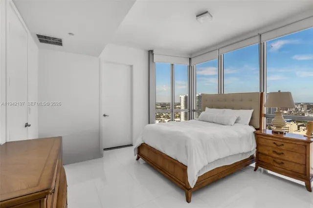 a bedroom with a bed and lamp