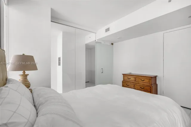 a bedroom with a bed and a lamp