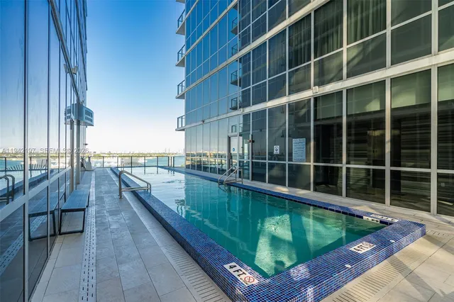 a view of a balcony with a large window and wooden floor