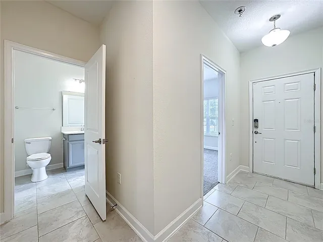 a bathroom with a toilet sink and a mirror