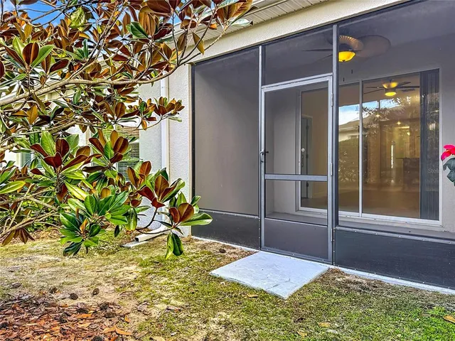 a backyard of a house with table and chairs