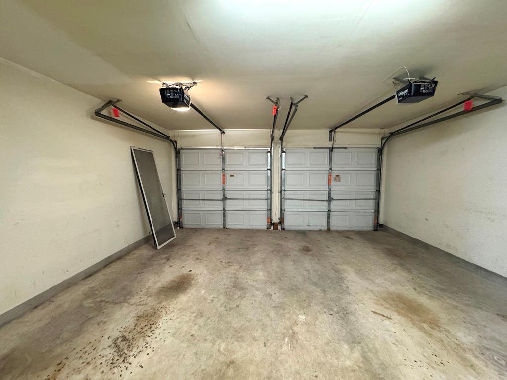 1009 Rutgers Drive Pflugerville, TX 78660 - Photo 38 of 40 Ample space for vehicles and storage with dual garage doors.