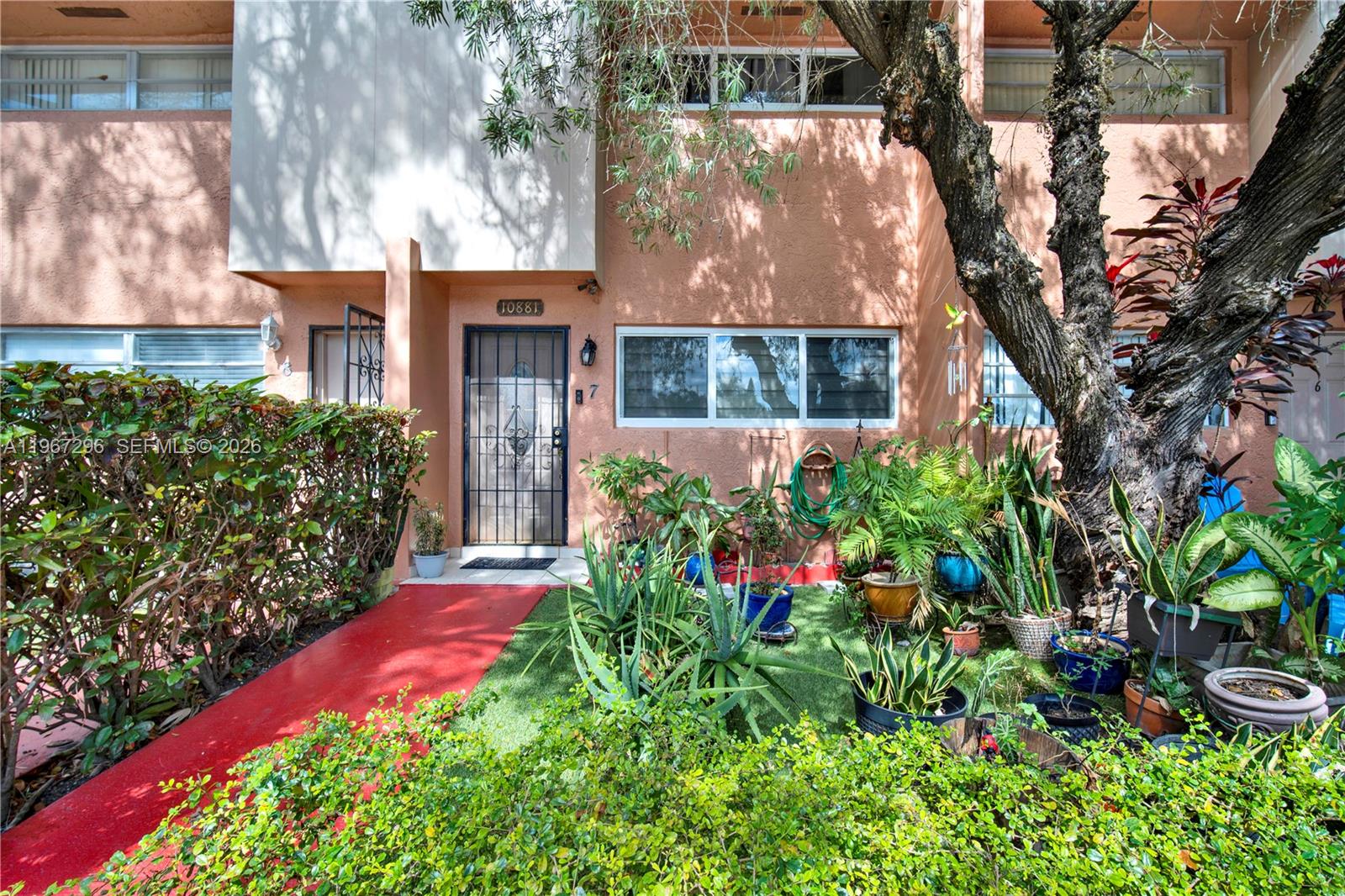 10881 Southwest 6th Street, Unit 7 Sweetwater, FL 33174 - Photo 1 of 34 front view of a house with a yard
