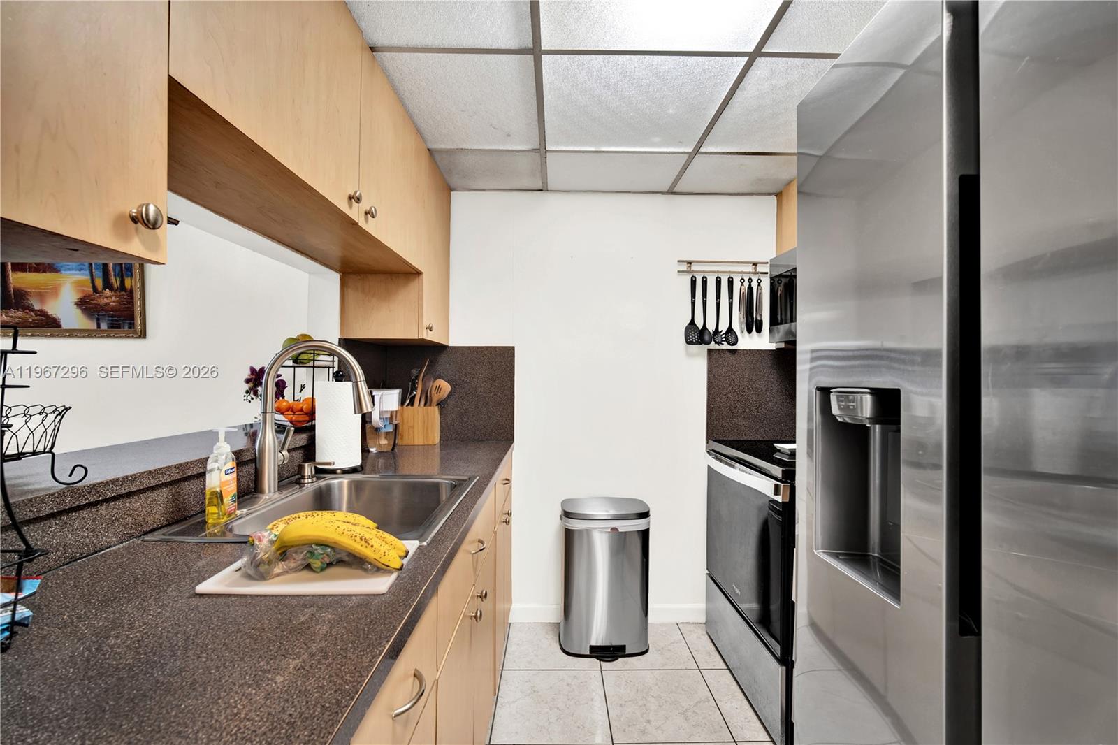 10881 Southwest 6th Street, Unit 7 Sweetwater, FL 33174 - Photo 11 of 34 a kitchen with refrigerator and washer