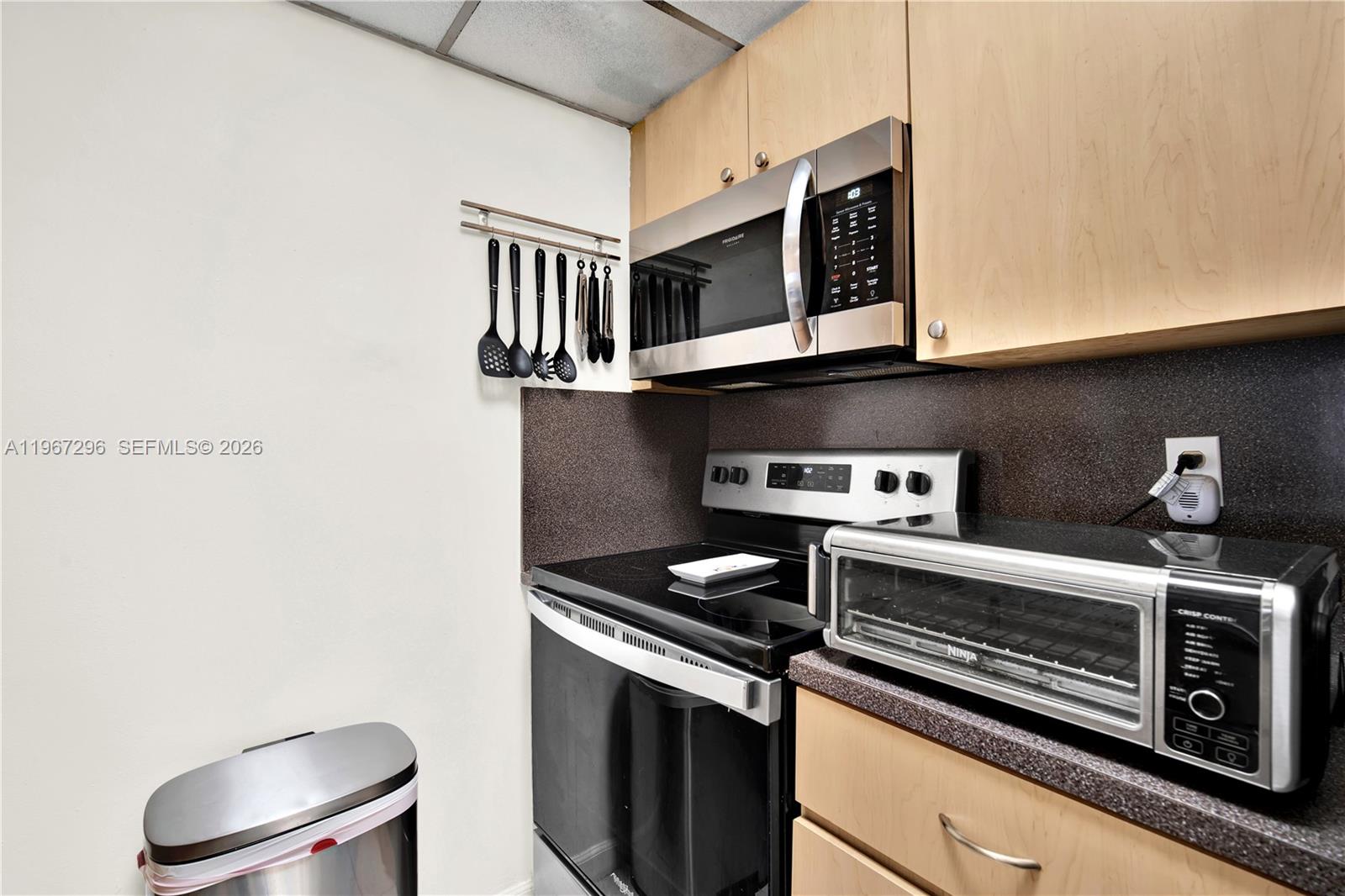 10881 Southwest 6th Street, Unit 7 Sweetwater, FL 33174 - Photo 12 of 34 a kitchen with a stove and a microwave