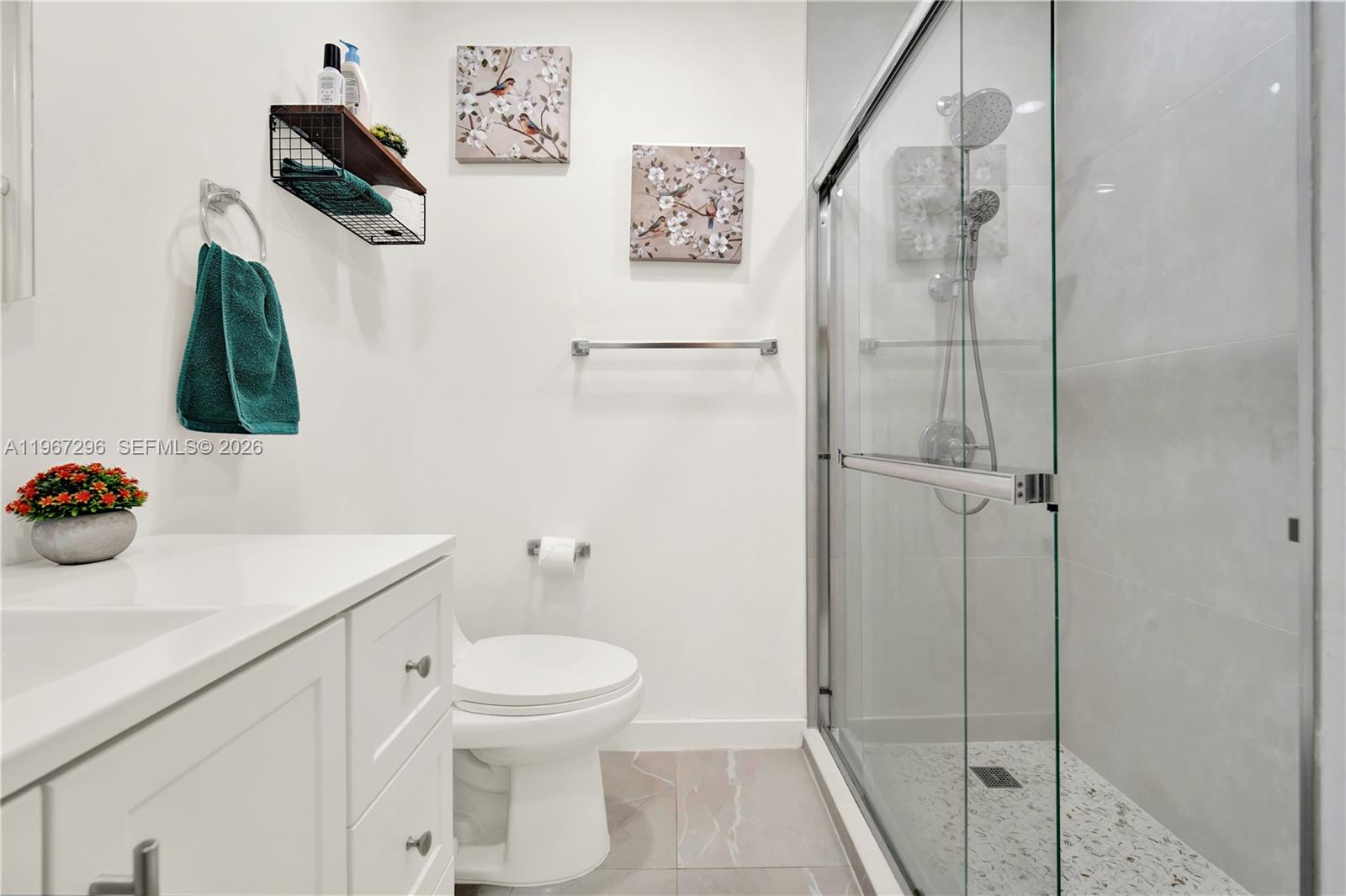 10881 Southwest 6th Street, Unit 7 Sweetwater, FL 33174 - Photo 17 of 34 a bathroom with a sink a toilet and shower