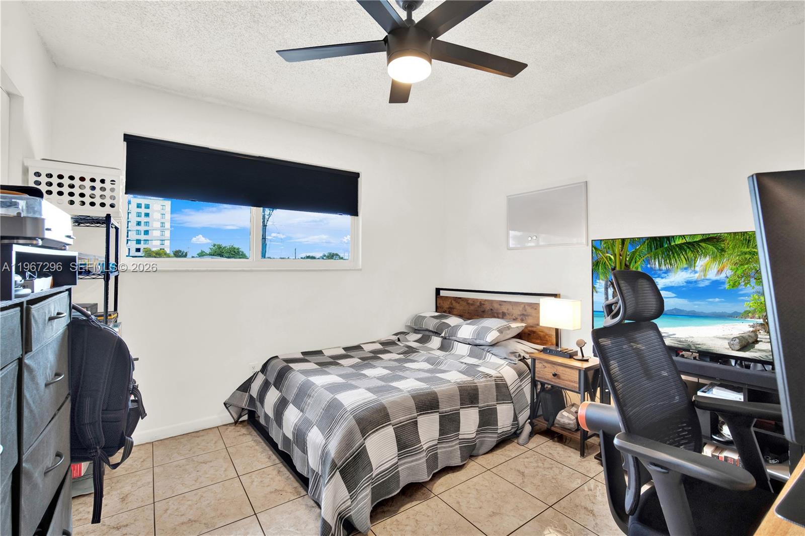 10881 Southwest 6th Street, Unit 7 Sweetwater, FL 33174 - Photo 20 of 34 a bedroom with double bed and a window
