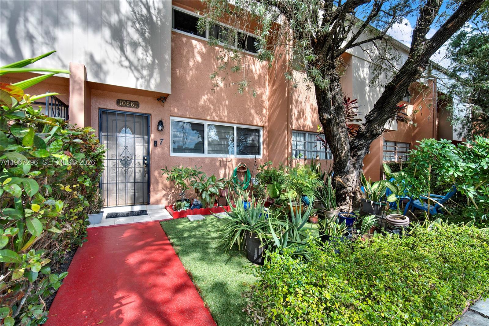 10881 Southwest 6th Street, Unit 7 Sweetwater, FL 33174 - Photo 2 of 34 front view of a house with a yard