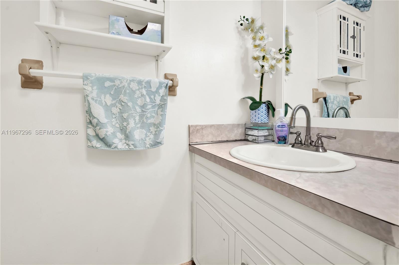 10881 Southwest 6th Street, Unit 7 Sweetwater, FL 33174 - Photo 21 of 34 a bathroom with a sink and a mirror