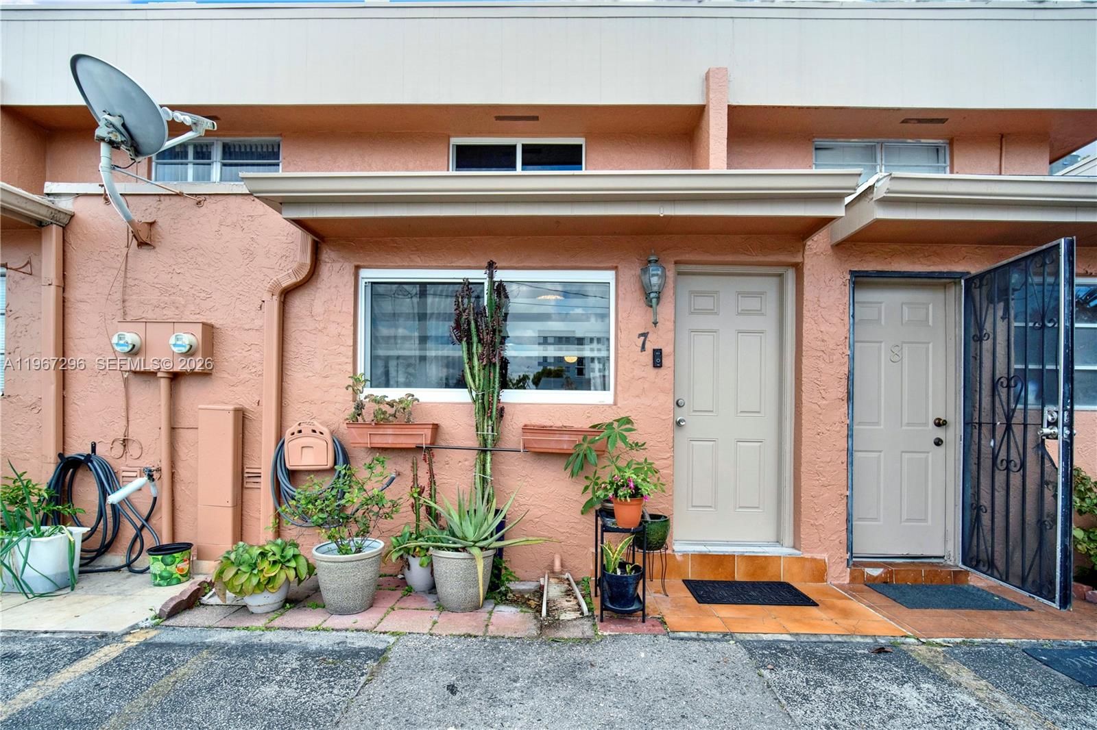 10881 Southwest 6th Street, Unit 7 Sweetwater, FL 33174 - Photo 24 of 34 a view of a building with potted plants