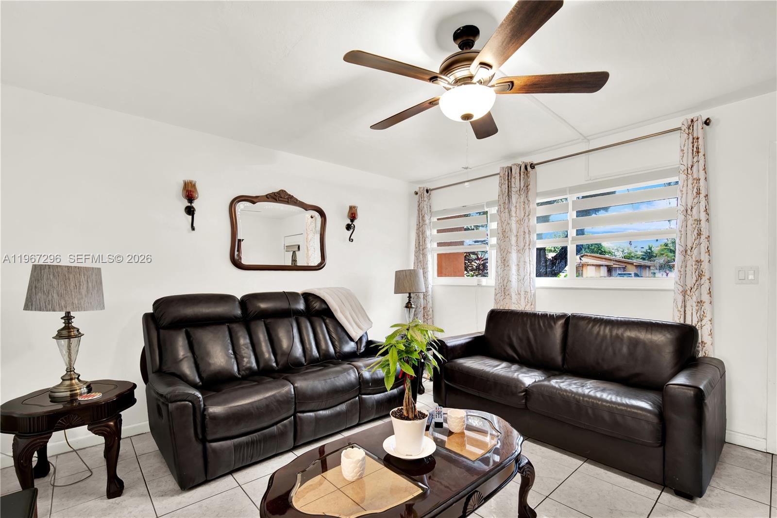 10881 Southwest 6th Street, Unit 7 Sweetwater, FL 33174 - Photo 6 of 34 a living room with furniture ceiling fan and a window