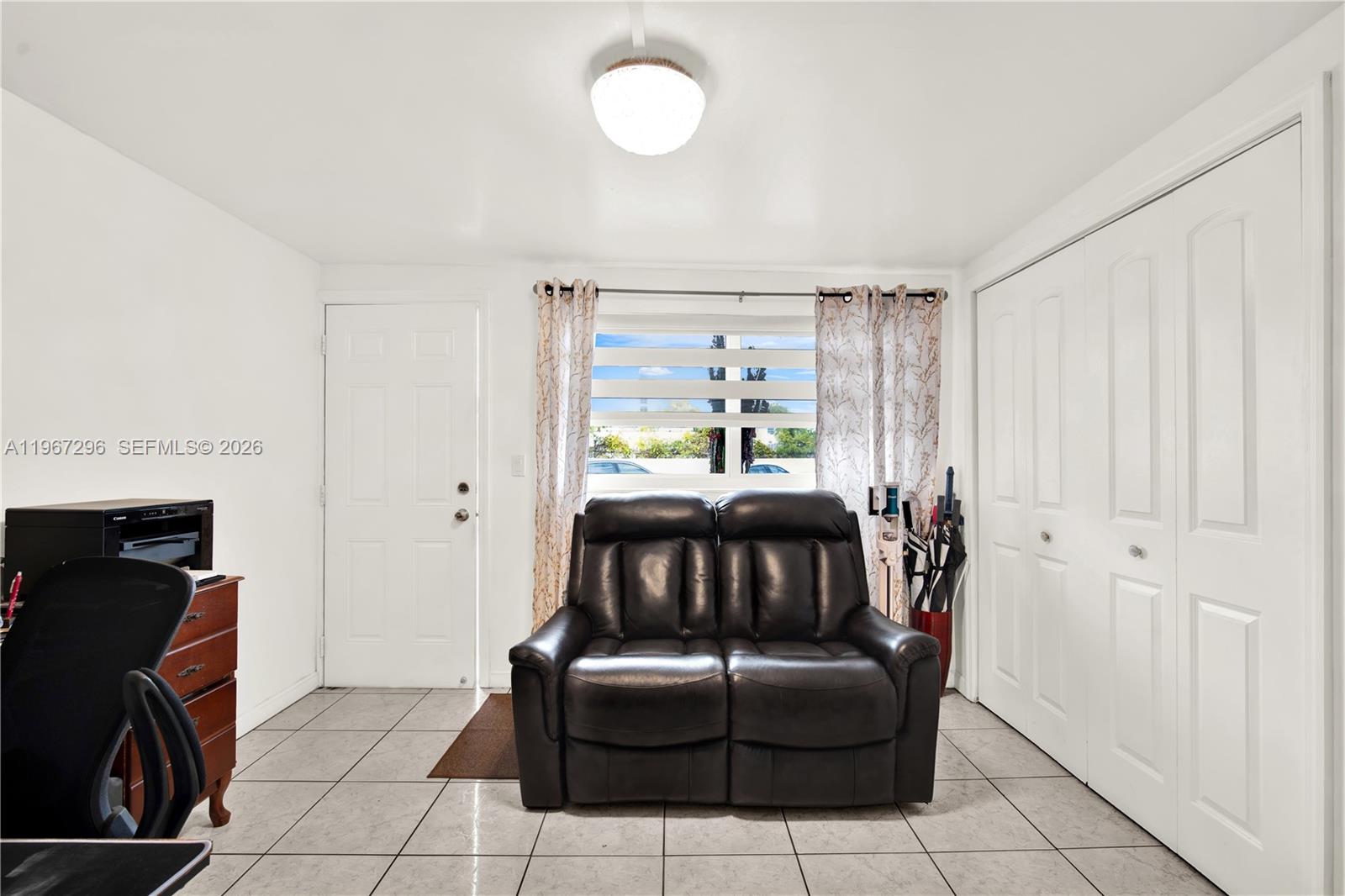 10881 Southwest 6th Street, Unit 7 Sweetwater, FL 33174 - Photo 7 of 34 a living room with furniture and a fireplace