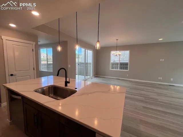 a kitchen with center island wooden floor and windows