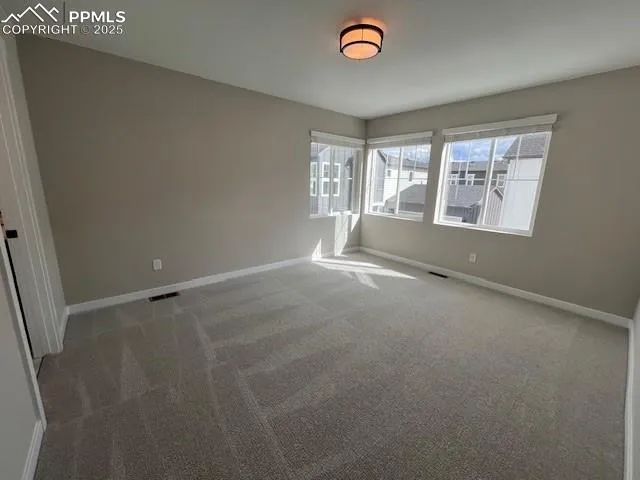 an empty room with a empty space and windows