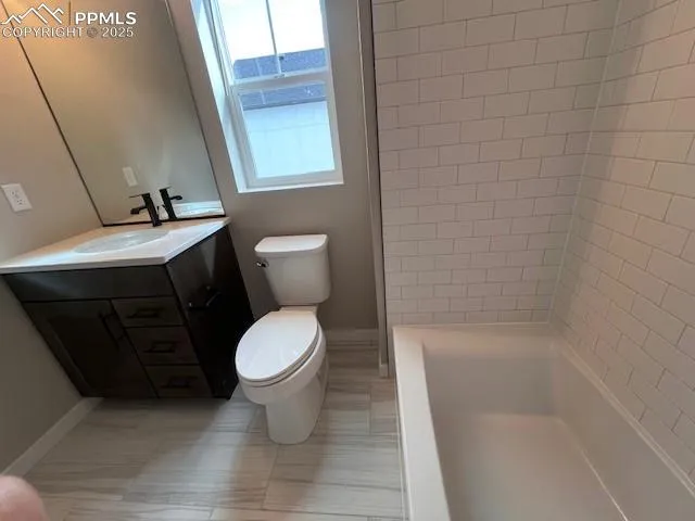 a bathroom with a toilet and a sink