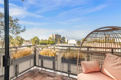 a view of roof deck with a barbeque and wooden stairs