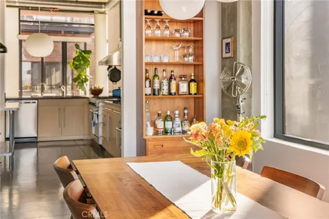 a dining room with furniture and wooden floor