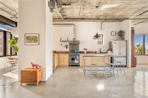 a living room with stainless steel appliances kitchen island granite countertop furniture and a kitchen view