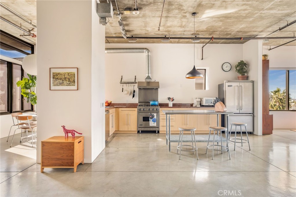 835 Locust Avenue, Unit 519 Long Beach, CA 90813 - Photo 16 of 42 a living room with stainless steel appliances kitchen island granite countertop furniture and a kitchen view