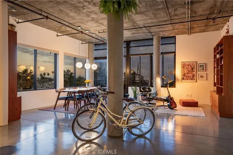 a view of hall with wooden floor and windows