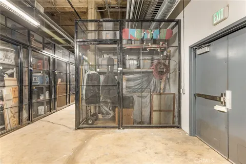 a view of a patio with chairs and umbrellas