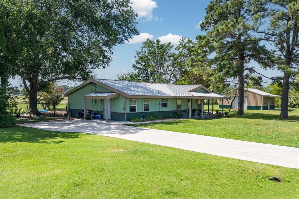 113 L B J Ranch Road Trinidad, TX 75163 - Photo 2 of 11 View of front of home featuring driveway and a metal roof