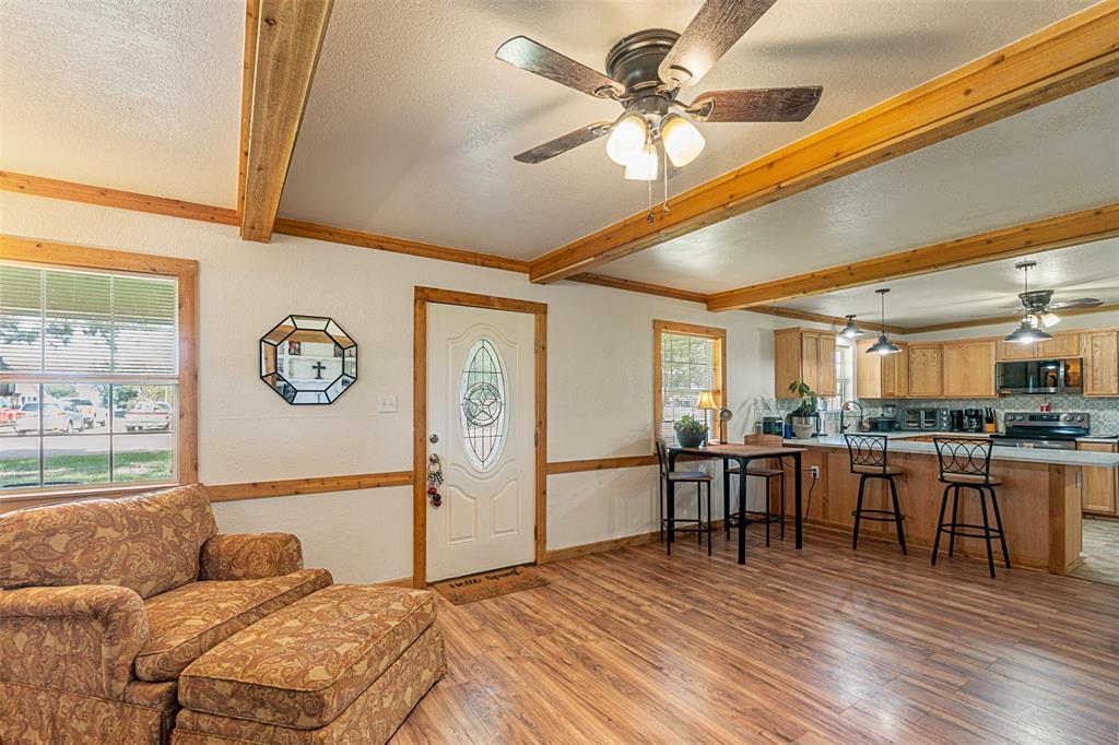 113 L B J Ranch Road Trinidad, TX 75163 - Photo 3 of 11 Entryway featuring ceiling fan, light wood-type flooring, beamed ceiling, healthy amount of natural light, and a textured ceiling