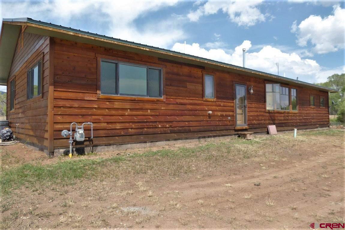 19850 2325th Road Cedaredge, CO 81413 - Photo 1 of 35 a front view of a house with a yard