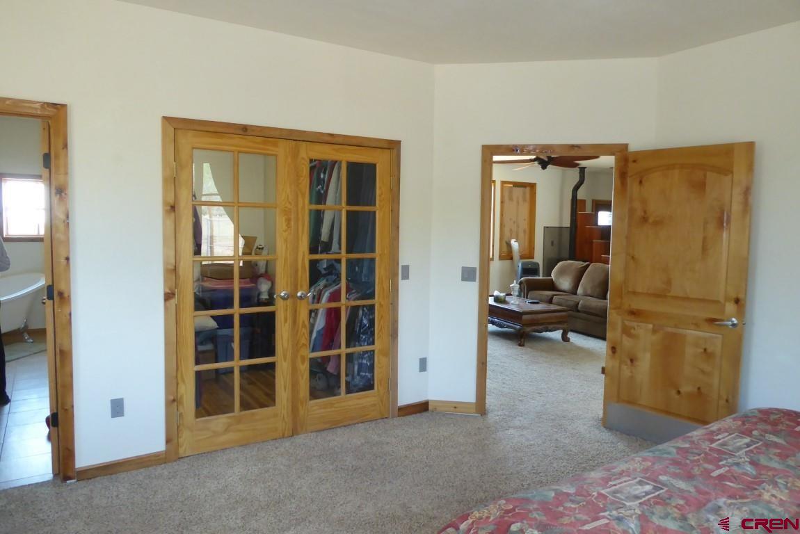19850 2325th Road Cedaredge, CO 81413 - Photo 18 of 35 a view of a bedroom with furniture and closet