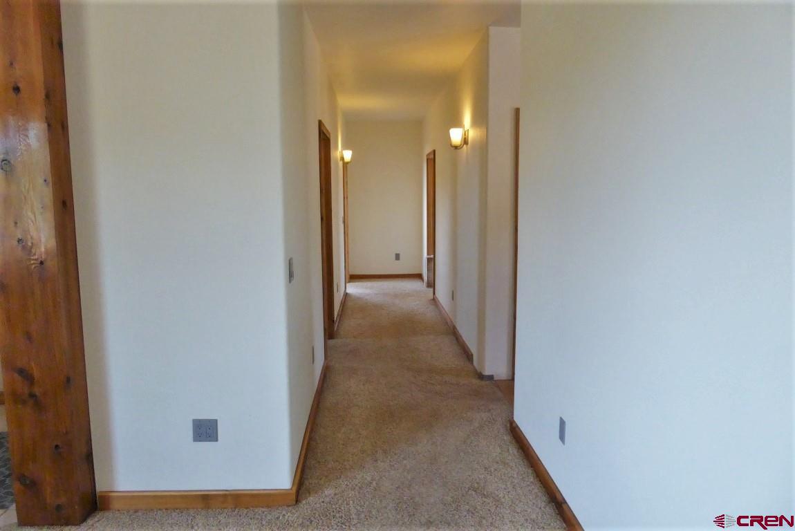 19850 2325th Road Cedaredge, CO 81413 - Photo 20 of 35 a view of a hallway with wooden floor