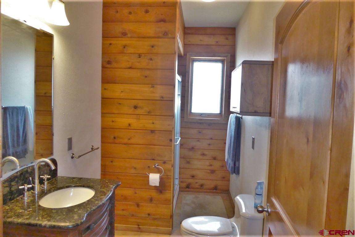 19850 2325th Road Cedaredge, CO 81413 - Photo 23 of 35 a bathroom with a sink toilet and shower