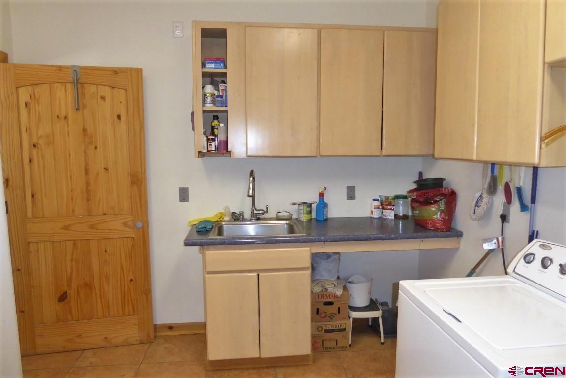 19850 2325th Road Cedaredge, CO 81413 - Photo 26 of 35 a kitchen with a sink and cabinets
