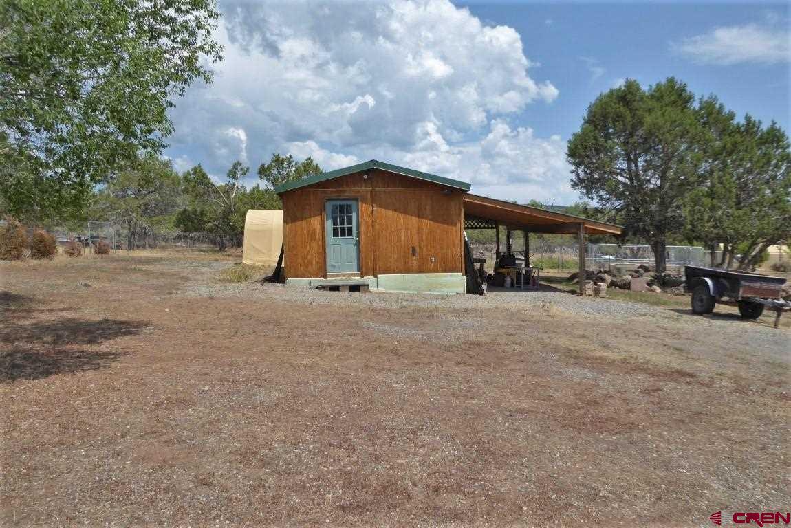 19850 2325th Road Cedaredge, CO 81413 - Photo 28 of 35 a view of outdoor space with deck and tree
