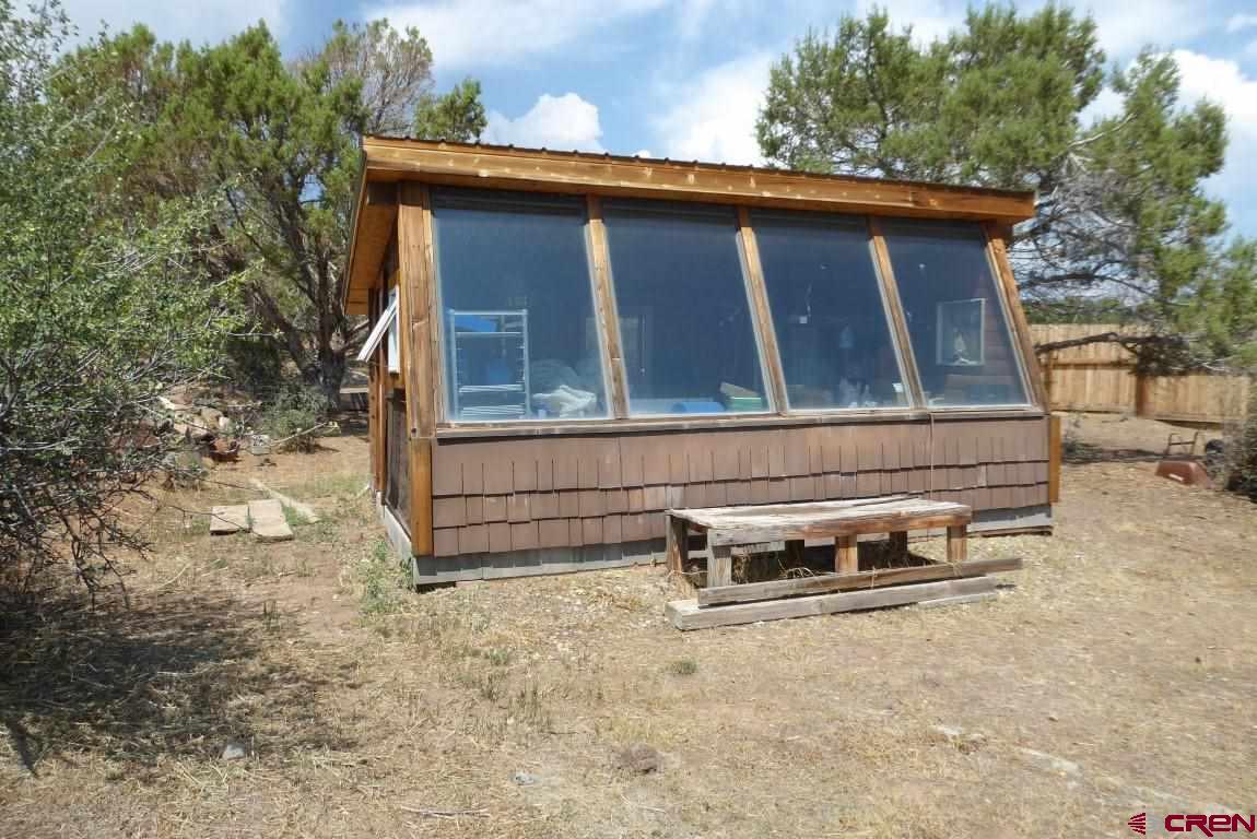 19850 2325th Road Cedaredge, CO 81413 - Photo 31 of 35 a view of a house with a yard