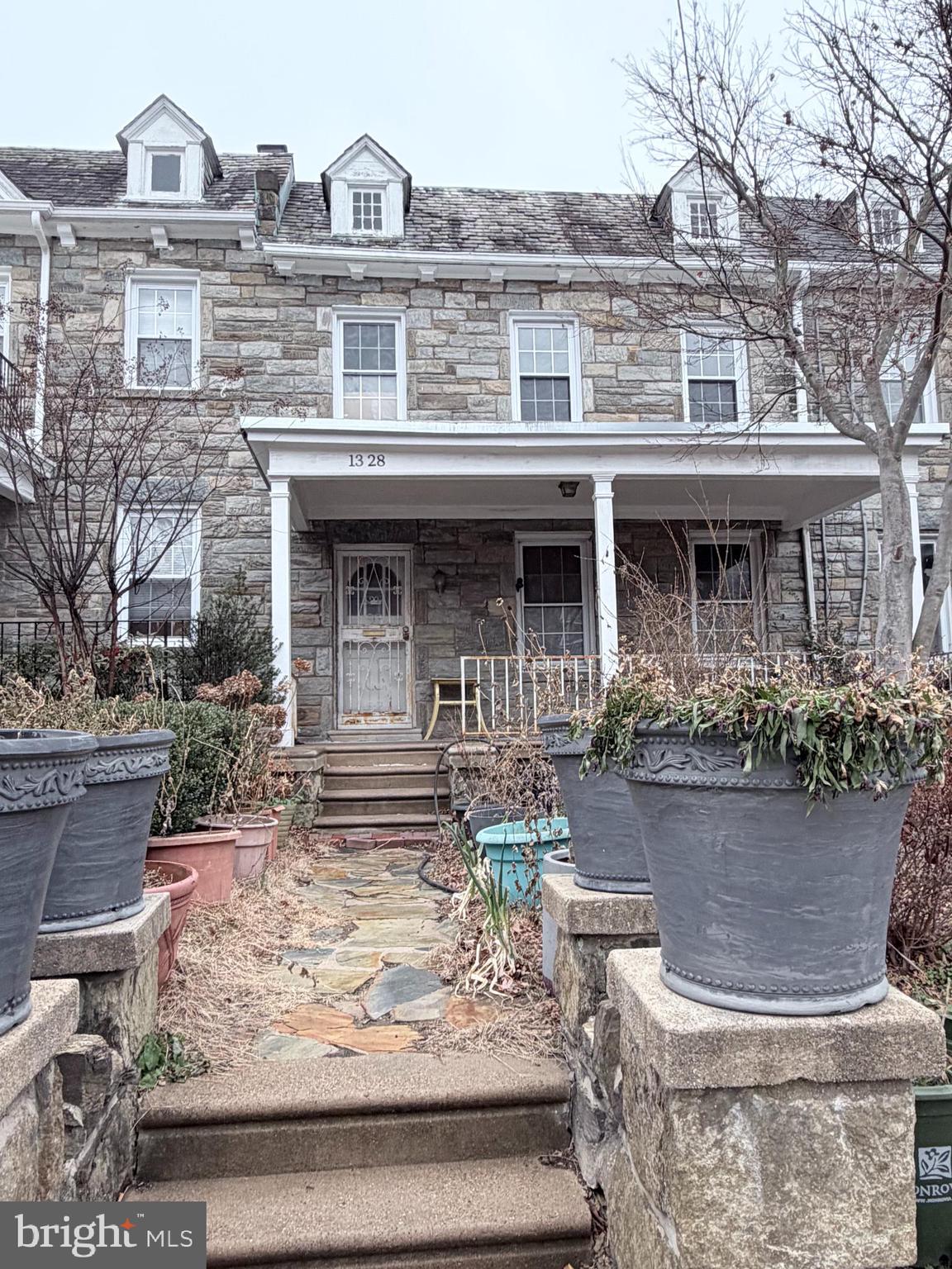 a front view of a house with garden and porch
