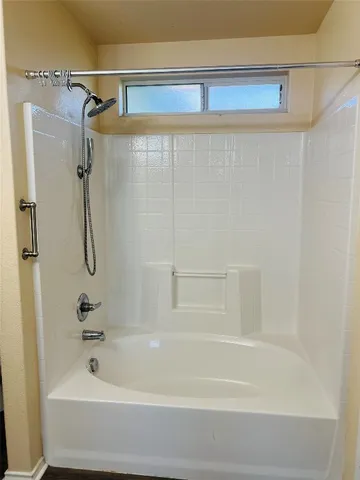 a bathroom with a shower and a bath tub