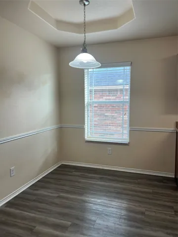a room with a window and a wooden floor