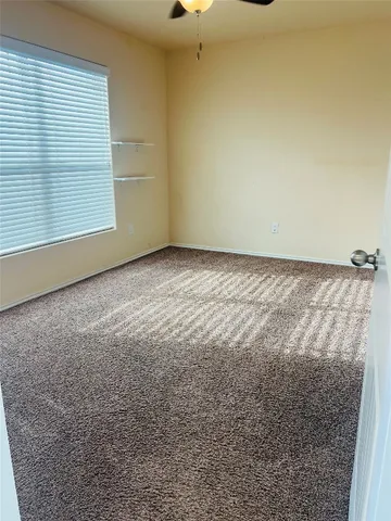 a view of empty room with ceiling fan