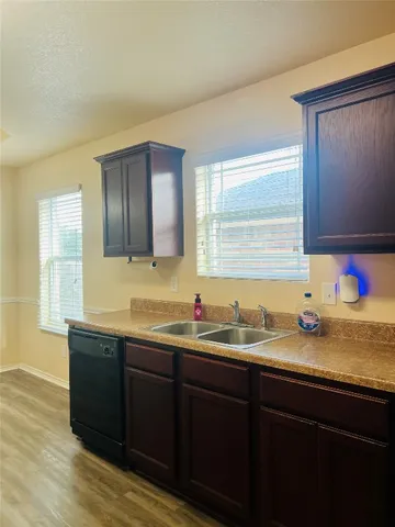 a kitchen with a sink and wooden cabinets