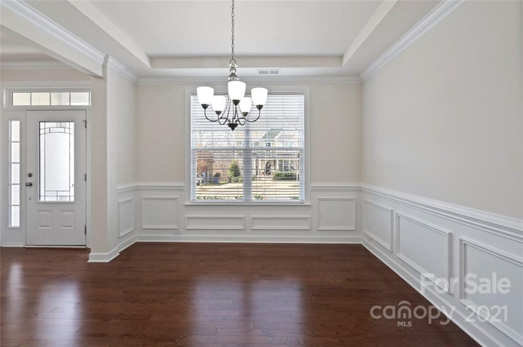 4331 Oxford Mill Road Waxhaw, NC 28173 - Photo 6 of 48 a view of an empty room with wooden floor and a window