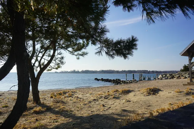 a view of a swimming pool with outdoor seating and lake view