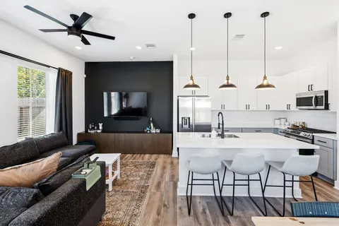 a view of living room with furniture and a chandelier