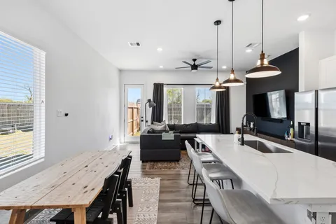 a large kitchen with a table and chairs